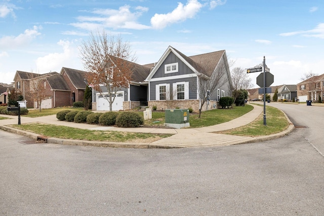 view of front of home with an attached garage, brick siding, driveway, a residential view, and board and batten siding