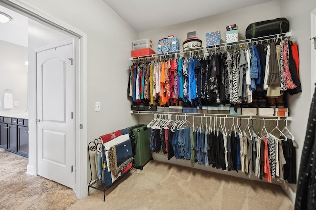 walk in closet featuring carpet floors