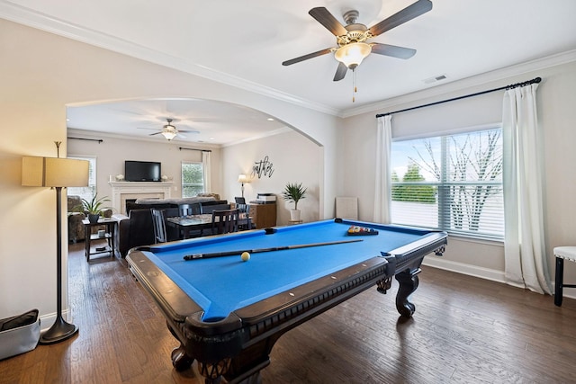 rec room featuring a fireplace, dark wood finished floors, visible vents, and a healthy amount of sunlight