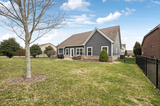 rear view of property with a patio, brick siding, a lawn, and a fenced backyard