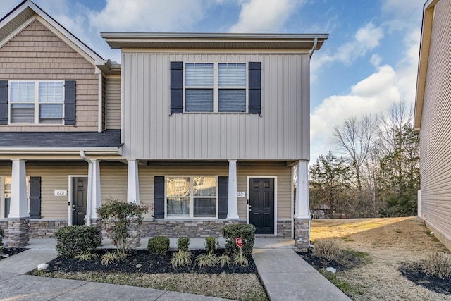 view of front of property with stone siding and a porch