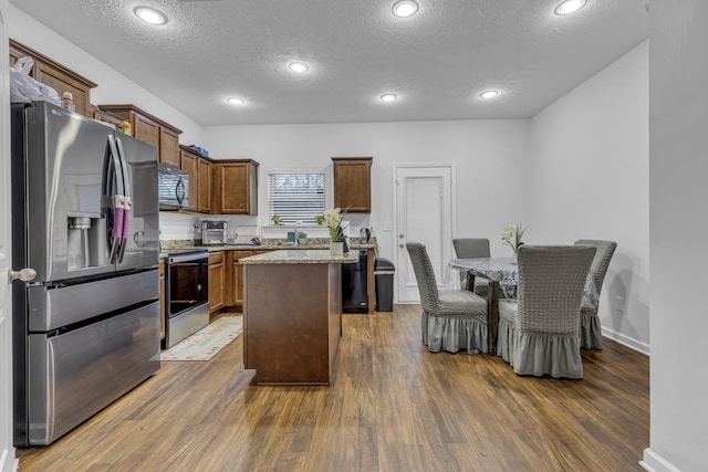 820 Lower Park Pl, Antioch, TN 37013 - kitchen featuring stainless steel appliances, a center island, dark wood finished floors, and a textured ceiling