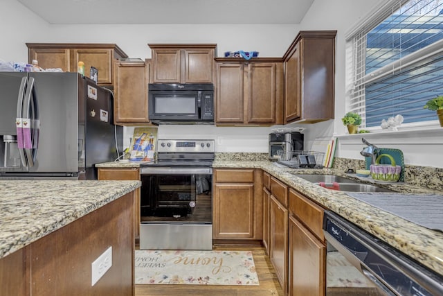820 Lower Park Pl, Antioch, TN 37013 - kitchen with light stone countertops, light wood finished floors, appliances with stainless steel finishes, and a sink