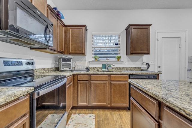 820 Lower Park Pl, Antioch, TN 37013 - kitchen featuring black microwave, stainless steel electric stove, a sink, light wood-type flooring, and light stone countertops