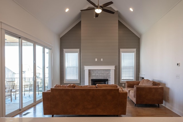 living room with light wood-type flooring, visible vents, plenty of natural light, and a fireplace