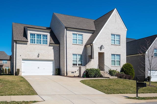 traditional-style home featuring a garage, concrete driveway, brick siding, and a front yard