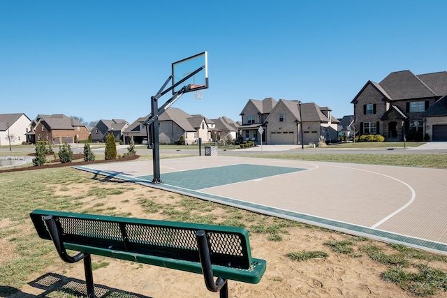 view of sport court with community basketball court, a lawn, and a residential view