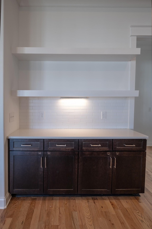 bar featuring tasteful backsplash and light wood finished floors