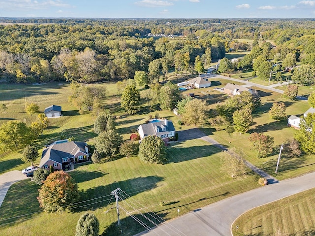 birds eye view of property featuring a wooded view