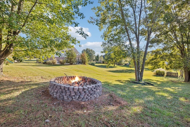 view of yard with a fire pit