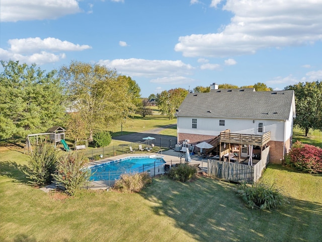 view of swimming pool featuring a fenced in pool, a playground, and a yard