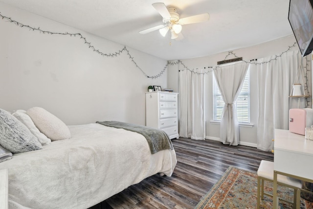 bedroom featuring ceiling fan, baseboards, and dark wood-type flooring