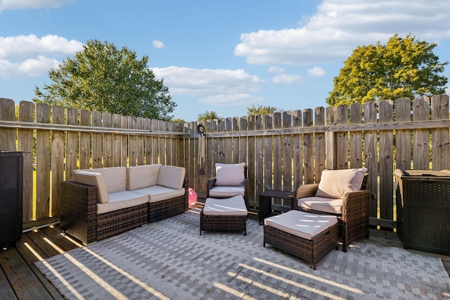 wooden deck with fence and an outdoor living space