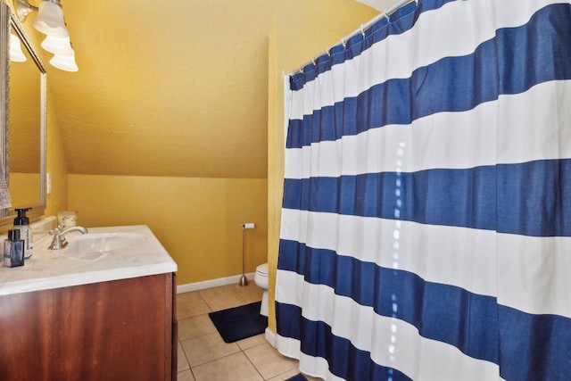 full bathroom featuring a shower with curtain, toilet, vanity, tile patterned flooring, and baseboards