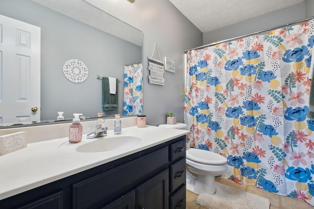 full bath featuring a textured ceiling, curtained shower, toilet, vanity, and tile patterned floors