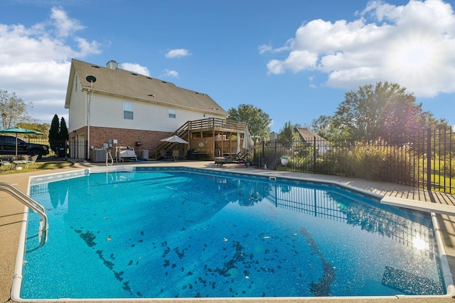 view of swimming pool with a fenced in pool, cooling unit, fence, and a patio