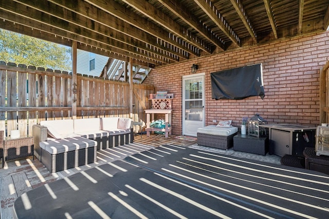 view of patio with outdoor lounge area and fence