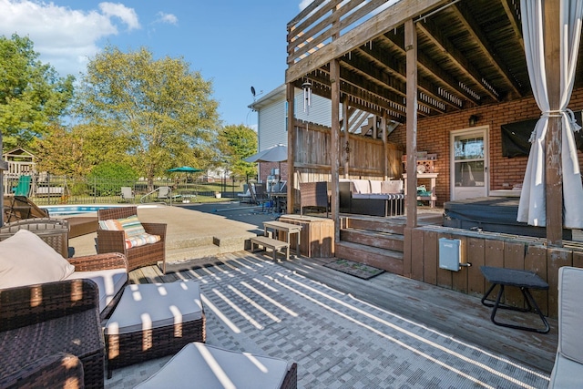 deck featuring a hot tub, a fenced in pool, an outdoor hangout area, fence, and a patio area