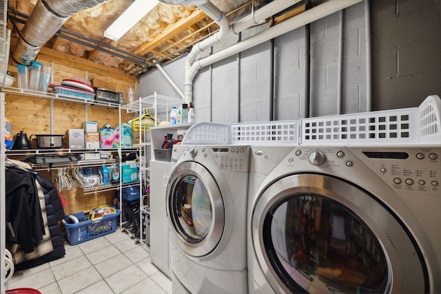 laundry area featuring laundry area, tile patterned flooring, and washing machine and clothes dryer