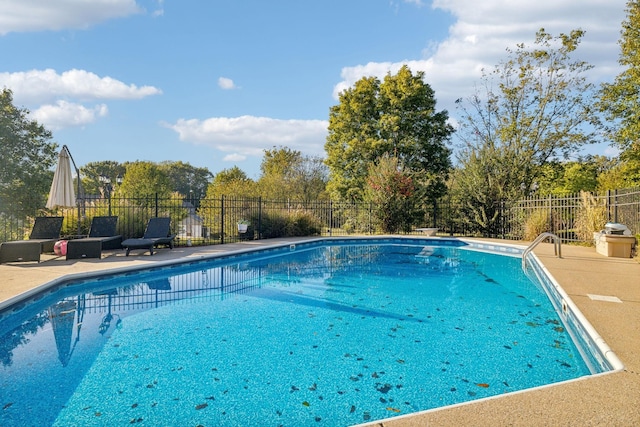 view of swimming pool featuring a fenced in pool, a patio area, and fence