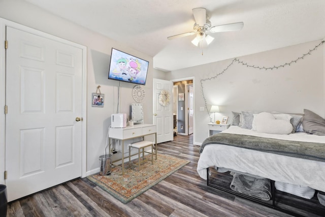 bedroom with a ceiling fan, baseboards, and wood finished floors