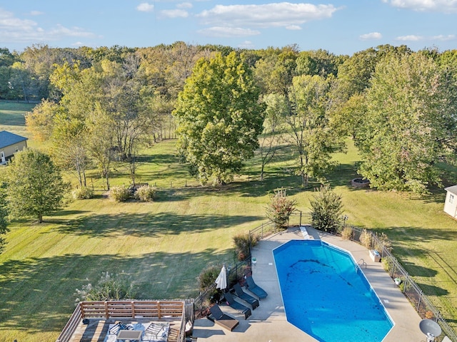 view of swimming pool with a patio, a yard, fence, and a fenced in pool