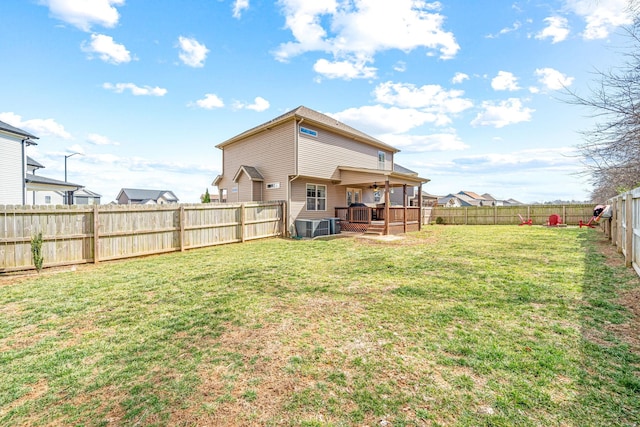 back of house with a lawn, cooling unit, and a fenced backyard