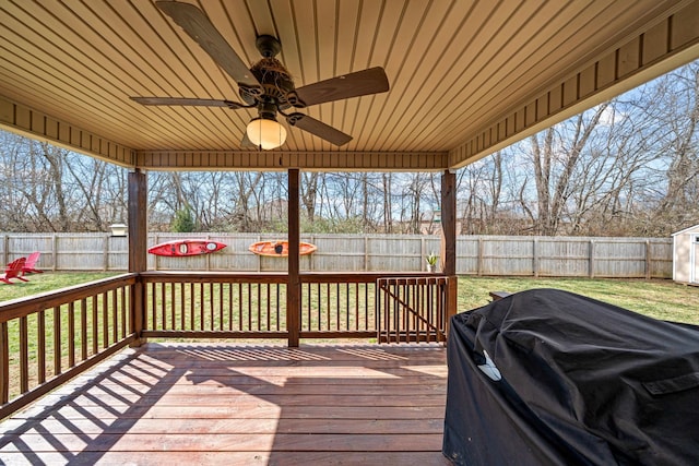 wooden terrace featuring a fenced backyard, ceiling fan, and area for grilling