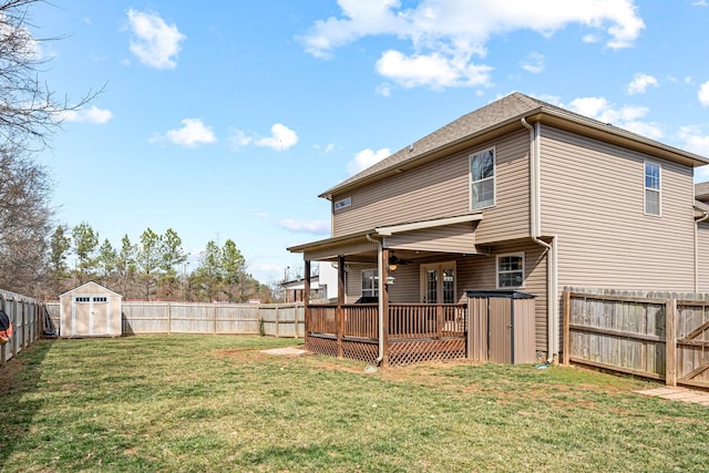 exterior space with an outbuilding, a fenced backyard, a deck, and a storage shed