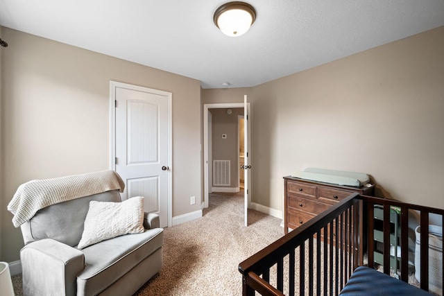 carpeted bedroom featuring visible vents and baseboards