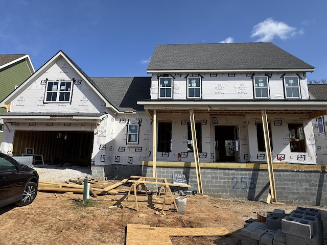 property in mid-construction with a porch, roof with shingles, and an attached garage