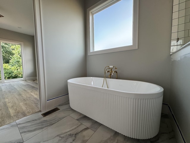 279 Hammock Dr, Winchester, TN 37398 - full bathroom featuring healthy amount of natural light, a soaking tub, and marble finish floors