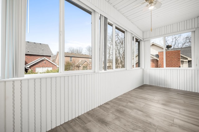 unfurnished sunroom with a ceiling fan