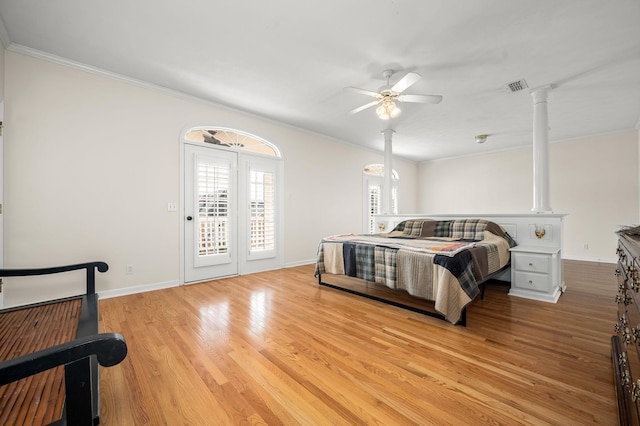 bedroom featuring access to exterior, crown molding, visible vents, light wood-style flooring, and baseboards