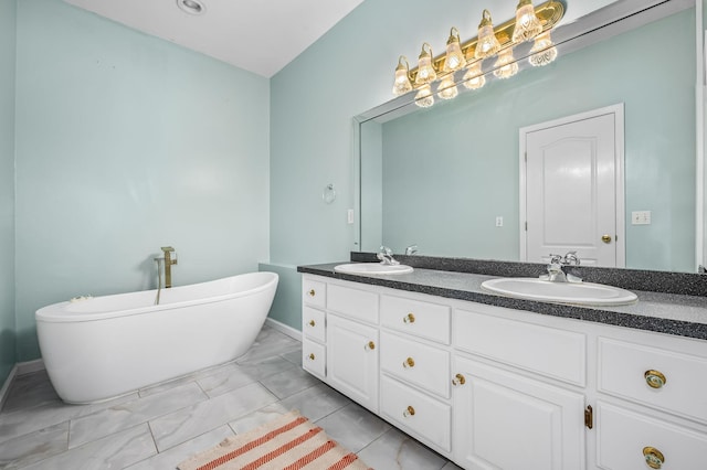 bathroom with double vanity, a freestanding tub, marble finish floor, and a sink