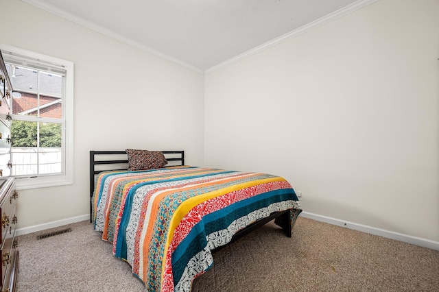 carpeted bedroom featuring baseboards, visible vents, and ornamental molding