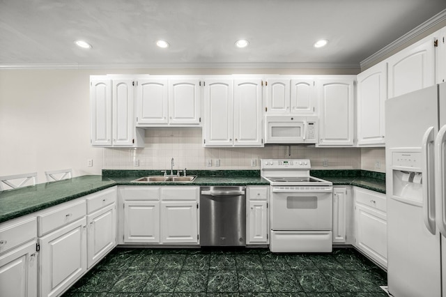 kitchen featuring white appliances, a sink, white cabinetry, tasteful backsplash, and dark countertops