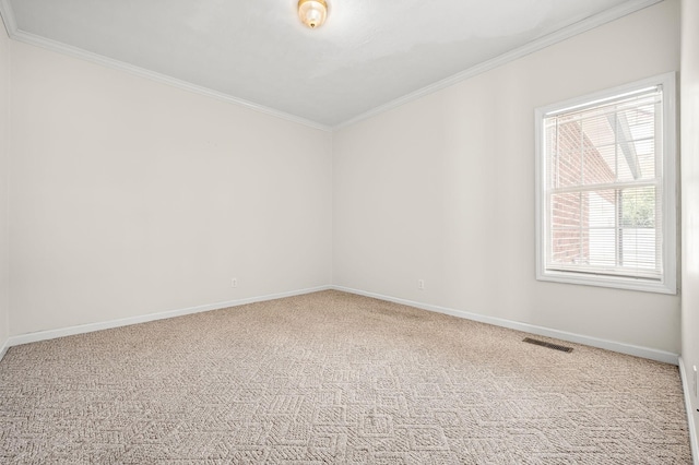 carpeted empty room with ornamental molding, visible vents, and baseboards