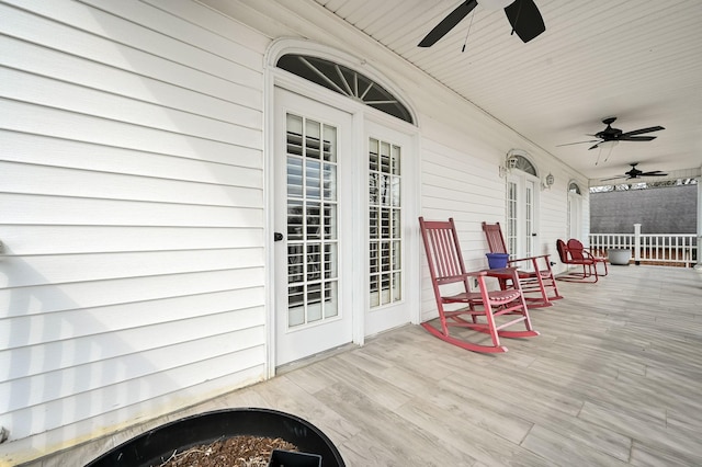 wooden deck featuring ceiling fan and a porch