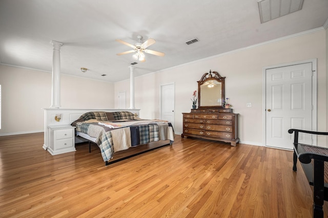 bedroom featuring light wood-style floors, visible vents, and ornamental molding