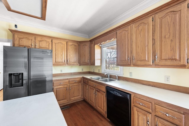 kitchen with dishwasher, light countertops, a sink, and stainless steel fridge