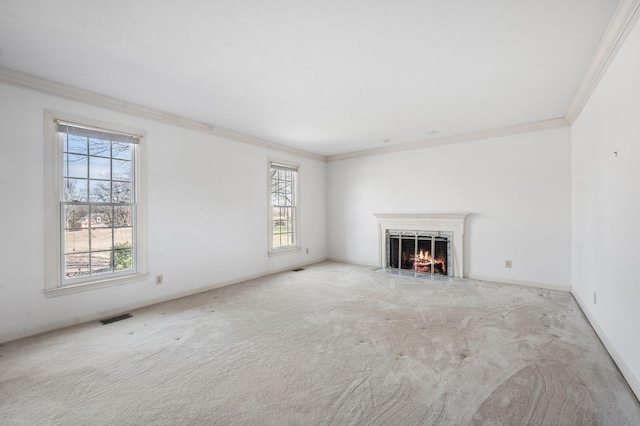 unfurnished living room featuring carpet, visible vents, crown molding, and a high end fireplace