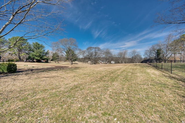 view of yard featuring a rural view and fence