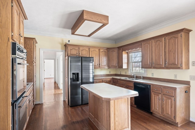 kitchen with dark wood-style flooring, light countertops, crown molding, black appliances, and a sink