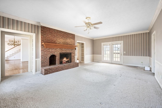 unfurnished living room with carpet, ornamental molding, a textured ceiling, and a brick fireplace