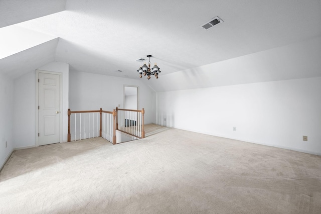 bonus room with lofted ceiling, visible vents, a chandelier, and light colored carpet