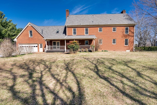 back of house featuring crawl space, brick siding, a chimney, and a lawn