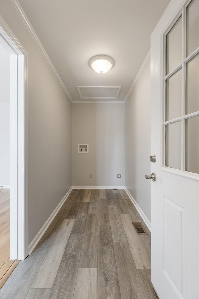 laundry area featuring laundry area, visible vents, ornamental molding, wood finished floors, and hookup for a washing machine