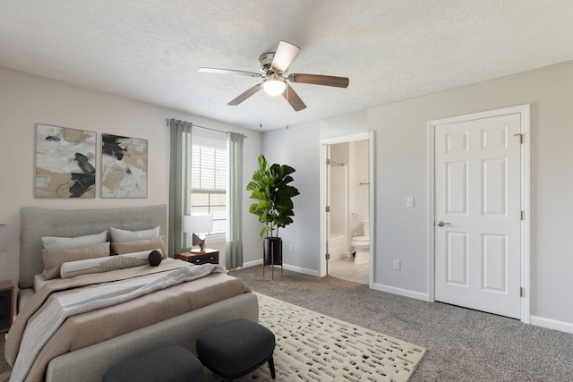 bedroom with carpet floors, connected bathroom, a textured ceiling, and baseboards