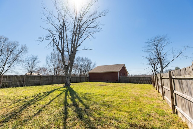 view of yard featuring a fenced backyard and an outbuilding